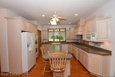 Step inside and discover a thoughtfully designed split ranch on Lost Lake Woods Club in Michigan - for sale on GolfHomes.com, golf home, golf lot