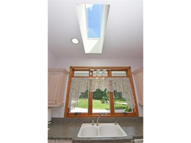 Step inside and discover a thoughtfully designed split ranch on Lost Lake Woods Club in Michigan - for sale on GolfHomes.com, golf home, golf lot
