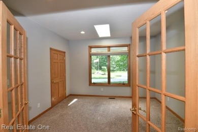 Step inside and discover a thoughtfully designed split ranch on Lost Lake Woods Club in Michigan - for sale on GolfHomes.com, golf home, golf lot