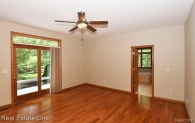 Step inside and discover a thoughtfully designed split ranch on Lost Lake Woods Club in Michigan - for sale on GolfHomes.com, golf home, golf lot