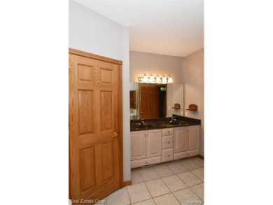 Step inside and discover a thoughtfully designed split ranch on Lost Lake Woods Club in Michigan - for sale on GolfHomes.com, golf home, golf lot