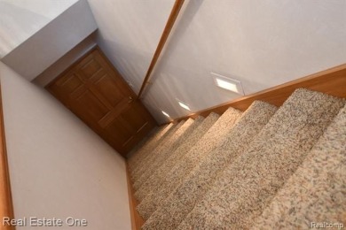Step inside and discover a thoughtfully designed split ranch on Lost Lake Woods Club in Michigan - for sale on GolfHomes.com, golf home, golf lot