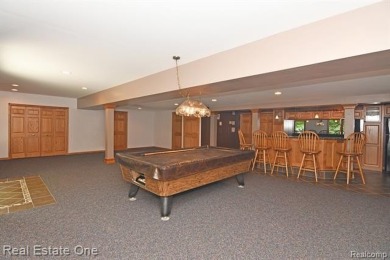 Step inside and discover a thoughtfully designed split ranch on Lost Lake Woods Club in Michigan - for sale on GolfHomes.com, golf home, golf lot