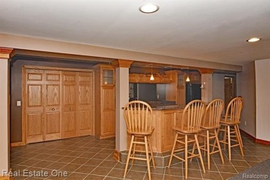 Step inside and discover a thoughtfully designed split ranch on Lost Lake Woods Club in Michigan - for sale on GolfHomes.com, golf home, golf lot