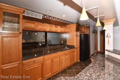 Step inside and discover a thoughtfully designed split ranch on Lost Lake Woods Club in Michigan - for sale on GolfHomes.com, golf home, golf lot