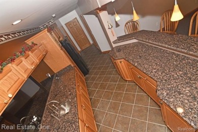 Step inside and discover a thoughtfully designed split ranch on Lost Lake Woods Club in Michigan - for sale on GolfHomes.com, golf home, golf lot