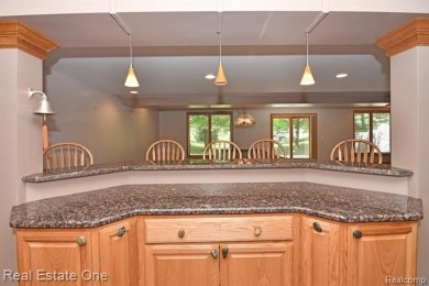 Step inside and discover a thoughtfully designed split ranch on Lost Lake Woods Club in Michigan - for sale on GolfHomes.com, golf home, golf lot