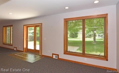Step inside and discover a thoughtfully designed split ranch on Lost Lake Woods Club in Michigan - for sale on GolfHomes.com, golf home, golf lot