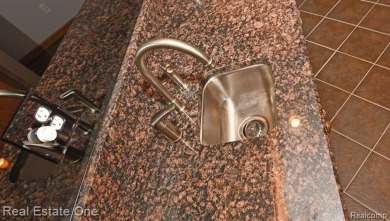 Step inside and discover a thoughtfully designed split ranch on Lost Lake Woods Club in Michigan - for sale on GolfHomes.com, golf home, golf lot