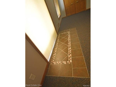 Step inside and discover a thoughtfully designed split ranch on Lost Lake Woods Club in Michigan - for sale on GolfHomes.com, golf home, golf lot