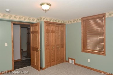 Step inside and discover a thoughtfully designed split ranch on Lost Lake Woods Club in Michigan - for sale on GolfHomes.com, golf home, golf lot