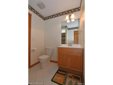 Step inside and discover a thoughtfully designed split ranch on Lost Lake Woods Club in Michigan - for sale on GolfHomes.com, golf home, golf lot