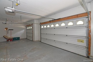 Step inside and discover a thoughtfully designed split ranch on Lost Lake Woods Club in Michigan - for sale on GolfHomes.com, golf home, golf lot