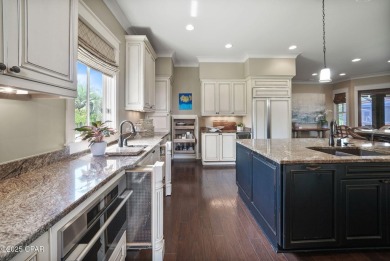 Nestled in a serene setting with views of a pond and golf course on Bay Point Resort Golf Club in Florida - for sale on GolfHomes.com, golf home, golf lot