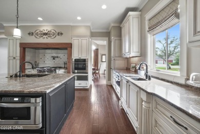 Nestled in a serene setting with views of a pond and golf course on Bay Point Resort Golf Club in Florida - for sale on GolfHomes.com, golf home, golf lot