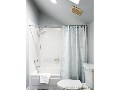 Experience unparalleled lakefront living with this stunning on The Oaks Golf Course in Missouri - for sale on GolfHomes.com, golf home, golf lot