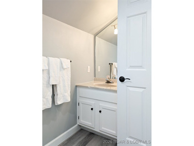 Experience unparalleled lakefront living with this stunning on The Oaks Golf Course in Missouri - for sale on GolfHomes.com, golf home, golf lot