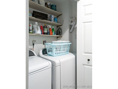 Experience unparalleled lakefront living with this stunning on The Oaks Golf Course in Missouri - for sale on GolfHomes.com, golf home, golf lot