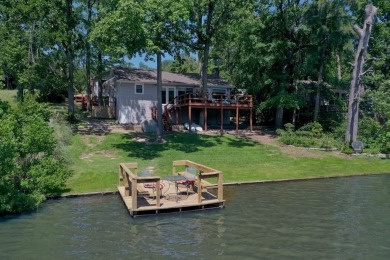 Welcome to a tranquil waterfront retreat nestled in the trees in on Hide-A-Way Lake Golf Course in Texas - for sale on GolfHomes.com, golf home, golf lot
