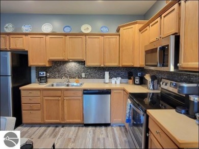 Enjoy resort-style living in this beautifully furnished condo on Schuss Mountain Golf Club in Michigan - for sale on GolfHomes.com, golf home, golf lot