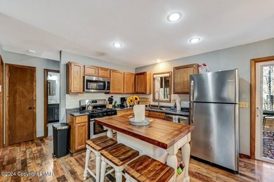 This Timber Trails three-generation family home in Lake Naomi on Lake Naomi Timber Trails Golf Club in Pennsylvania - for sale on GolfHomes.com, golf home, golf lot