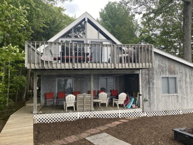 This unique cottage sits right on the waters edge with a sandy on Frye Island Golf Club in Maine - for sale on GolfHomes.com, golf home, golf lot