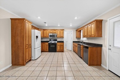 Welcome home this charming Fort Bayou Estates rancher with on Gulf Hills Golf Club in Mississippi - for sale on GolfHomes.com, golf home, golf lot