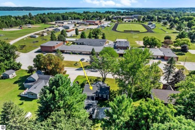 This four bedroom house with a double lot checks all the boxes on Elk Rapids Golf Club in Michigan - for sale on GolfHomes.com, golf home, golf lot