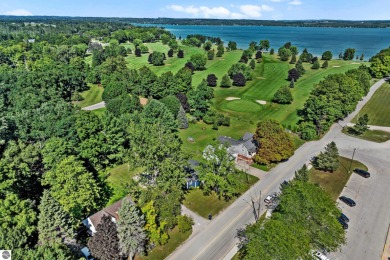 This four bedroom house with a double lot checks all the boxes on Elk Rapids Golf Club in Michigan - for sale on GolfHomes.com, golf home, golf lot