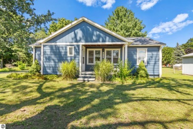 This four bedroom house with a double lot checks all the boxes on Elk Rapids Golf Club in Michigan - for sale on GolfHomes.com, golf home, golf lot