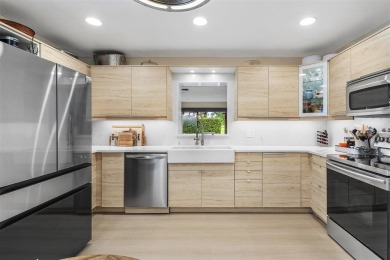 This impeccably remodeled 3 bdr residence is a true standout In on Woodmont Country Club in Florida - for sale on GolfHomes.com, golf home, golf lot