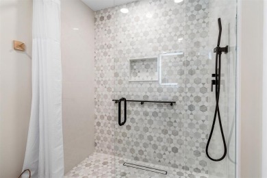 This impeccably remodeled 3 bdr residence is a true standout In on Woodmont Country Club in Florida - for sale on GolfHomes.com, golf home, golf lot