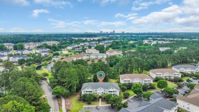 Pond and golf course views from the covered porch on this great on Barefoot Resort and Golf Club  in South Carolina - for sale on GolfHomes.com, golf home, golf lot