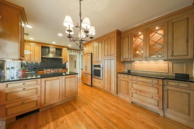 Discover the ease of single-level living with stunning vistas of on Country Club of Detroit - Regulation in Michigan - for sale on GolfHomes.com, golf home, golf lot