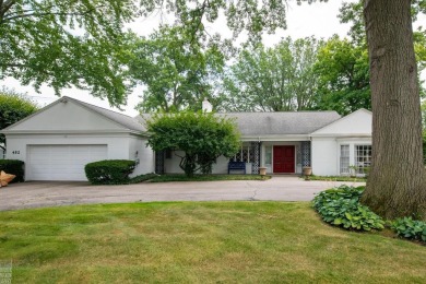 Discover the ease of single-level living with stunning vistas of on Country Club of Detroit - Regulation in Michigan - for sale on GolfHomes.com, golf home, golf lot