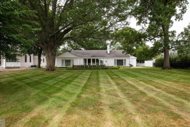Discover the ease of single-level living with stunning vistas of on Country Club of Detroit - Regulation in Michigan - for sale on GolfHomes.com, golf home, golf lot