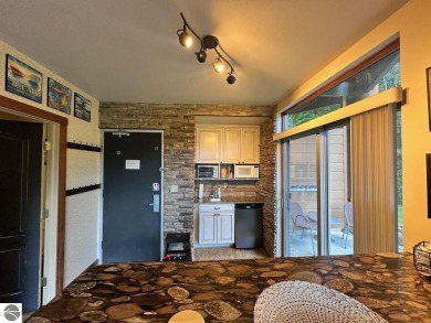 Fully furnished corner unit at the Lodge at Cedar River Village on Cedar River Golf Course in Michigan - for sale on GolfHomes.com, golf home, golf lot