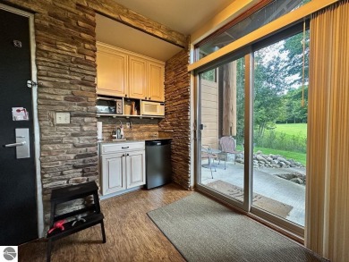 Fully furnished corner unit at the Lodge at Cedar River Village on Cedar River Golf Course in Michigan - for sale on GolfHomes.com, golf home, golf lot