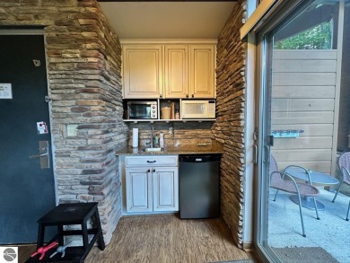 Fully furnished corner unit at the Lodge at Cedar River Village on Cedar River Golf Course in Michigan - for sale on GolfHomes.com, golf home, golf lot