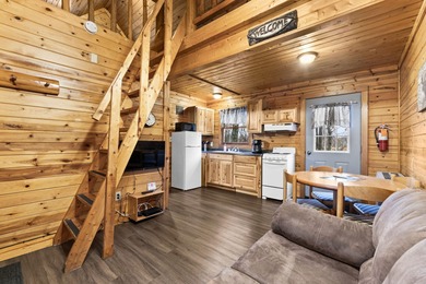 Charming and cozy, this Beaver Creek Resort cabin offers the on The Loon Golf Resort in Michigan - for sale on GolfHomes.com, golf home, golf lot
