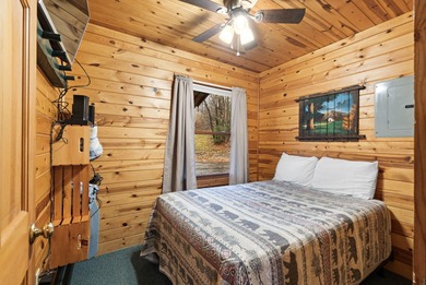 Charming and cozy, this Beaver Creek Resort cabin offers the on The Loon Golf Resort in Michigan - for sale on GolfHomes.com, golf home, golf lot