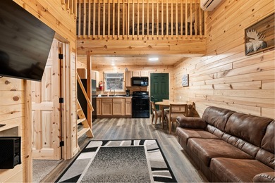 Adorable and inviting, this 2-bedroom, 1-bath Beaver Creek cabin on The Loon Golf Resort in Michigan - for sale on GolfHomes.com, golf home, golf lot