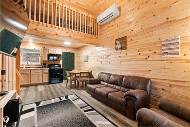 Adorable and inviting, this 2-bedroom, 1-bath Beaver Creek cabin on The Loon Golf Resort in Michigan - for sale on GolfHomes.com, golf home, golf lot