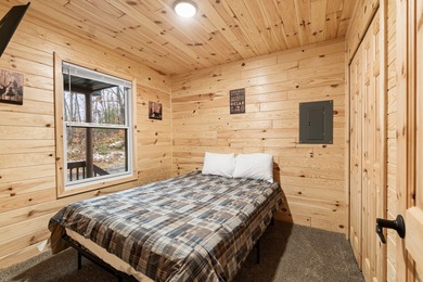 Adorable and inviting, this 2-bedroom, 1-bath Beaver Creek cabin on The Loon Golf Resort in Michigan - for sale on GolfHomes.com, golf home, golf lot
