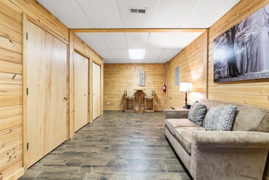 Discover this inviting Beaver Creek Resort cabin, offering the on The Loon Golf Resort in Michigan - for sale on GolfHomes.com, golf home, golf lot