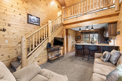 Discover this inviting Beaver Creek Resort cabin, offering the on The Loon Golf Resort in Michigan - for sale on GolfHomes.com, golf home, golf lot