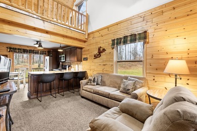 Discover this inviting Beaver Creek Resort cabin, offering the on The Loon Golf Resort in Michigan - for sale on GolfHomes.com, golf home, golf lot