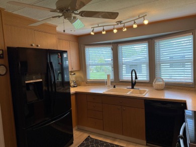 This lovely, manufacture home is on leased land in Lake Fairways on Pine Lakes Country Club in Florida - for sale on GolfHomes.com, golf home, golf lot