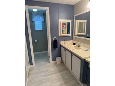 This lovely, manufacture home is on leased land in Lake Fairways on Pine Lakes Country Club in Florida - for sale on GolfHomes.com, golf home, golf lot
