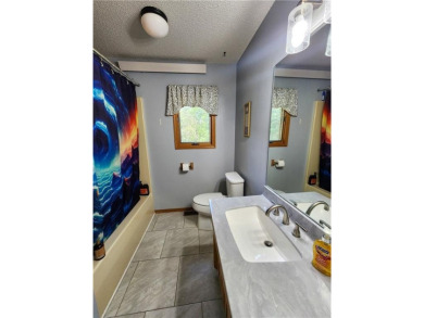 Welcome to this inviting Bella Vista corner-lot home designed on Bella Vista - Metfield Golf Complex and Country Club in Arkansas - for sale on GolfHomes.com, golf home, golf lot